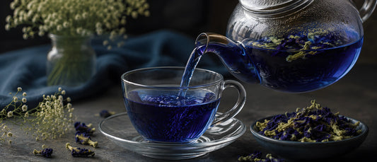 butterfly pea flower tea being poured into a glass cup